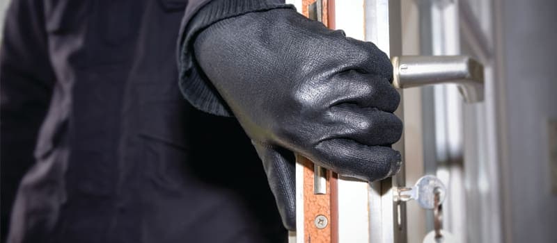 Burglar breaking into a house