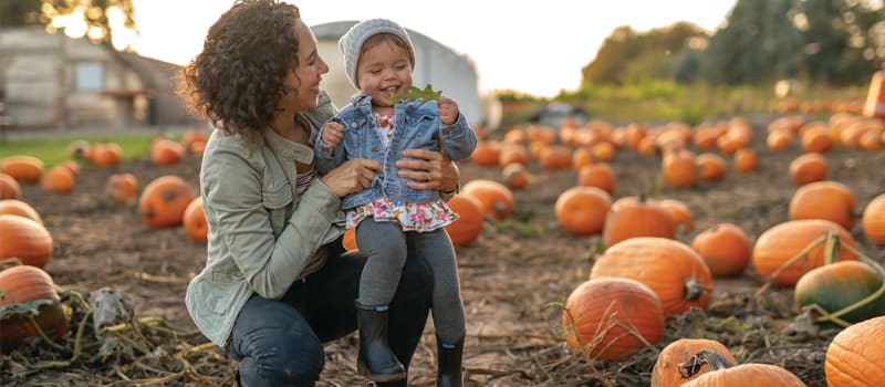 Mother and daughter in a pumpkin patch