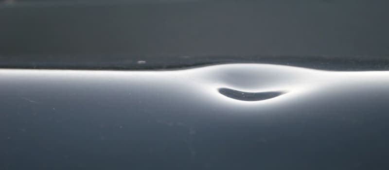 Car hood dented from hail
