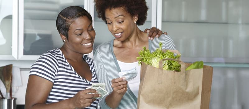 Two women checking their grocey store receipt