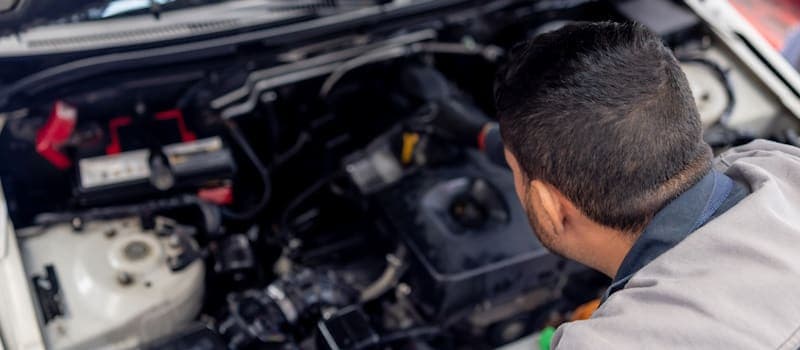 Man checking a car engine