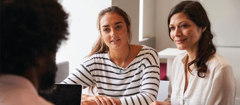 Mother and daughter talking to a counselor