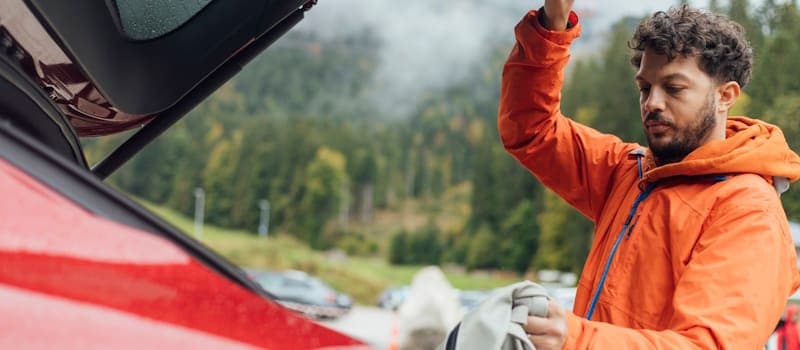 Man inspecting his car