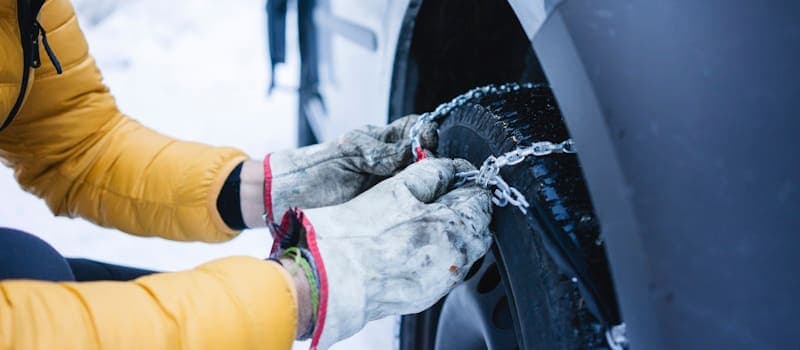 Man putting on tire chains