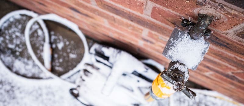 Frozen outdoor spigot with hose attached